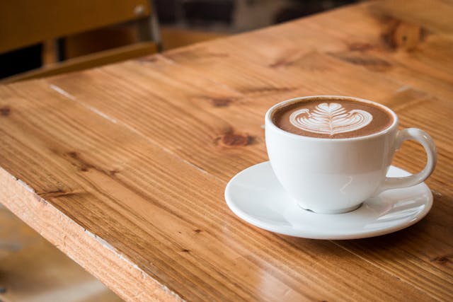 a coffee in a white mug on a wooden table